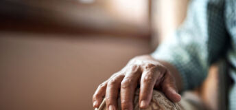 Elderly person sitting in armchair