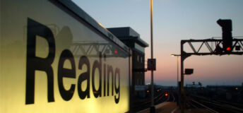 A sign that reads "Reading" on the platform at Reading Train Station