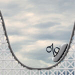 A rollercoaster with a percentage sign sat on the rollercoaster's cart