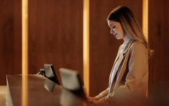 Woman working at a hotel reception desk